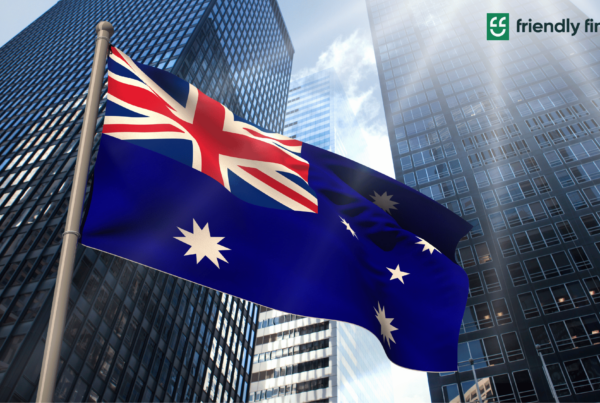 A picture of the Australian flag with tall skyscrapers in its background